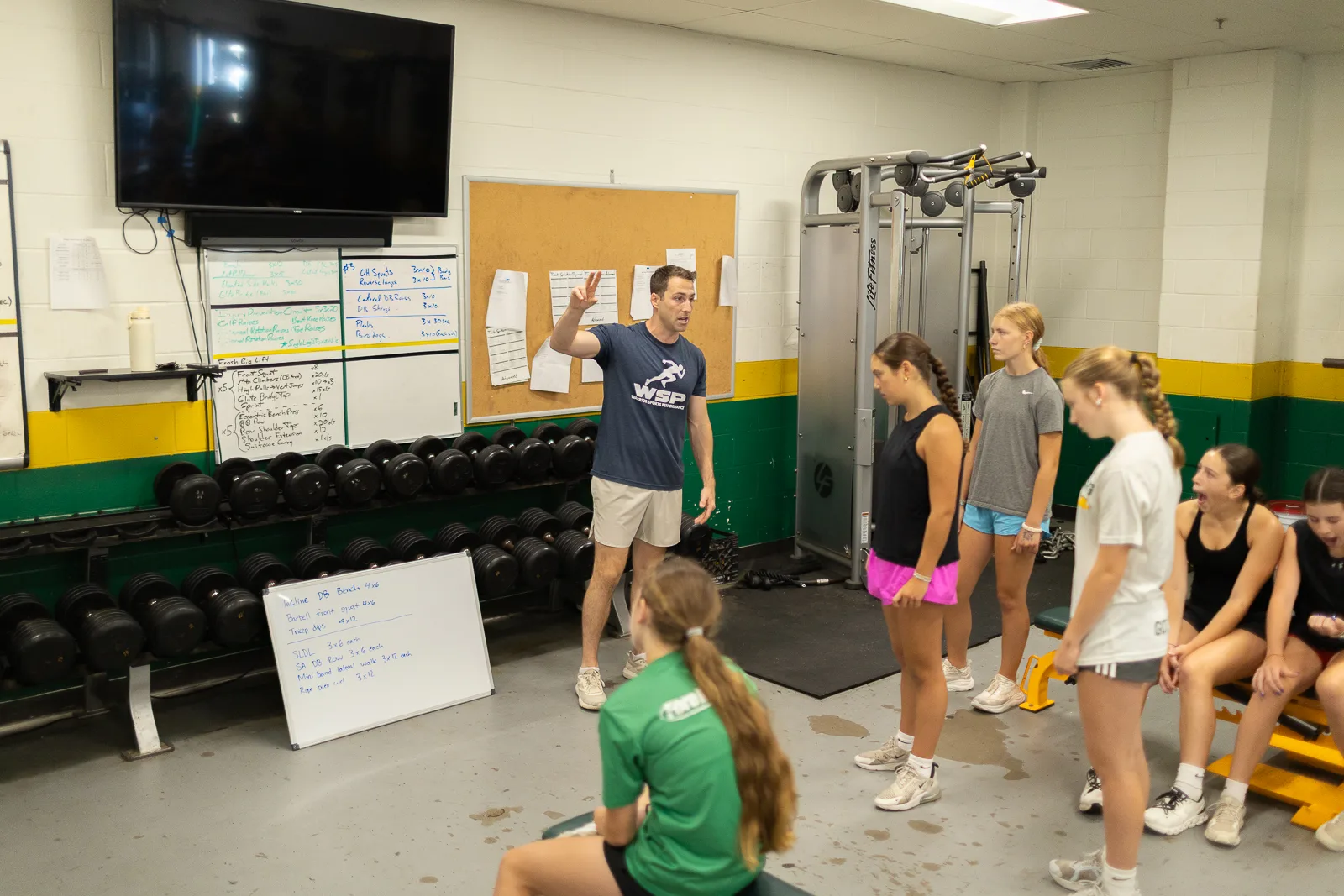 Coach guiding a gym session