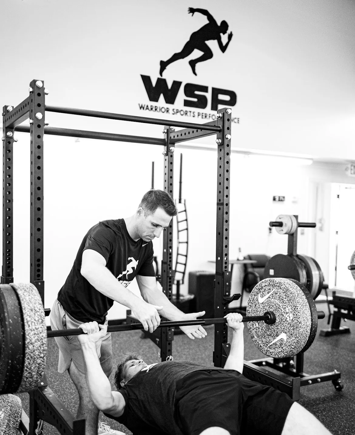 WSP coach guiding an athlete through a squat