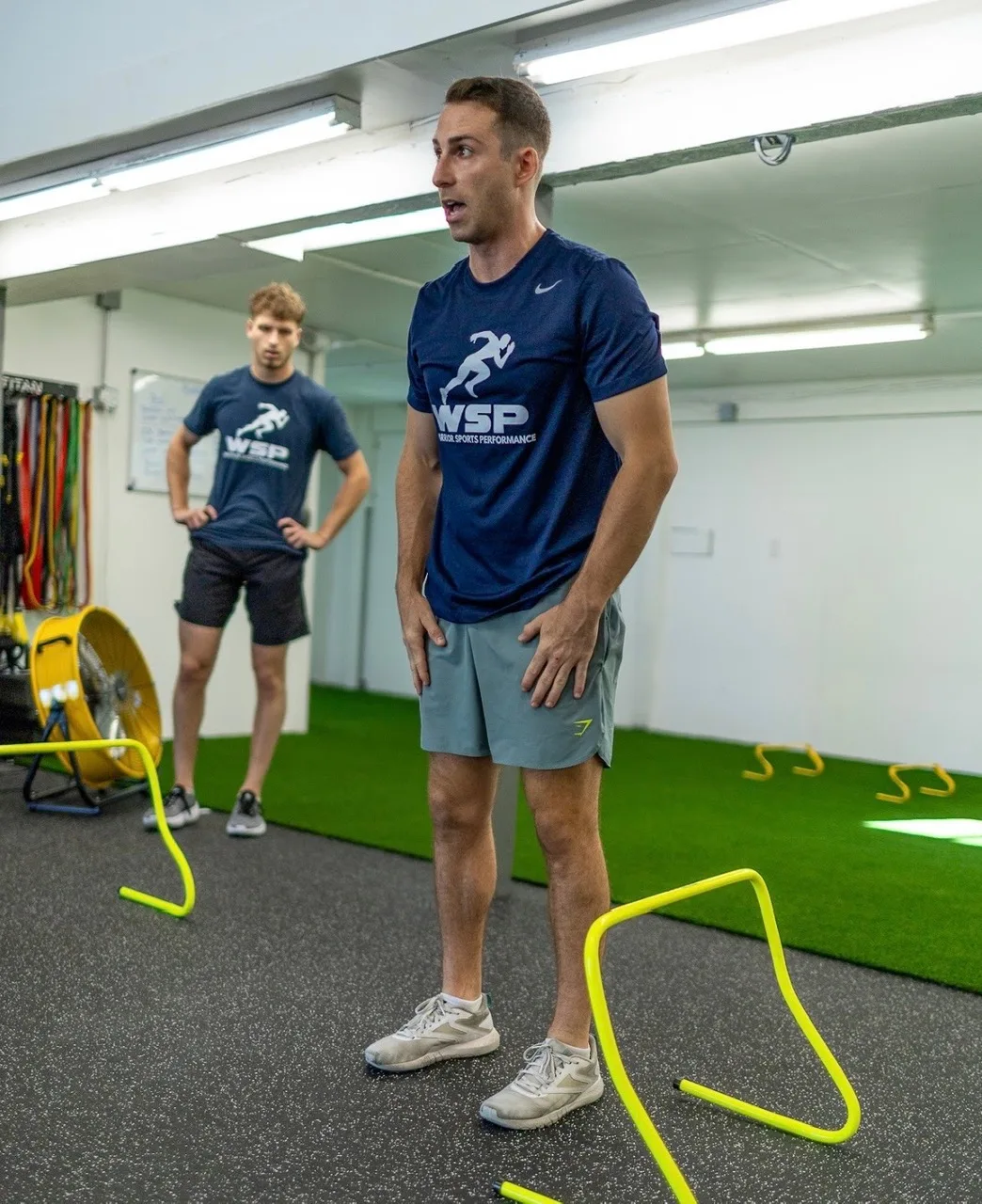 Coach demonstrating a hurdle drill