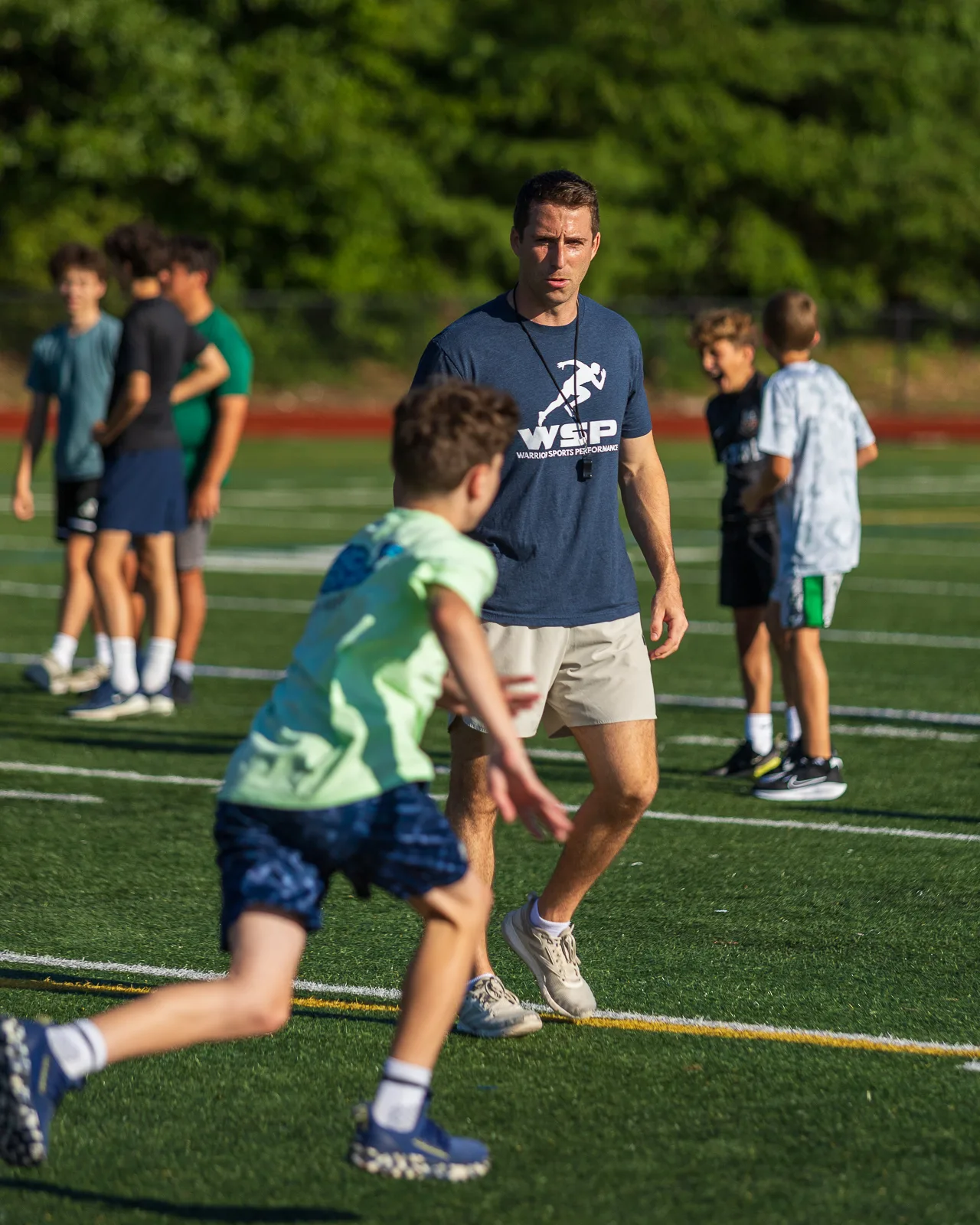 Coach guiding a sprint drill