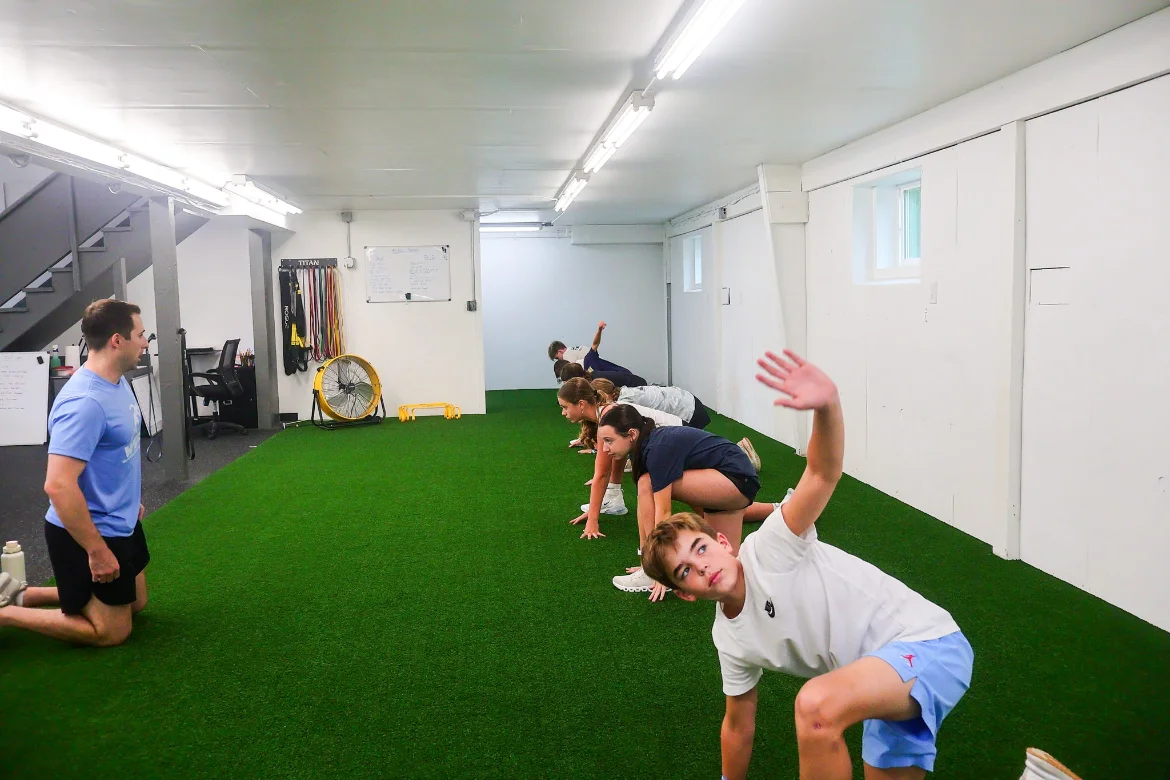 Athletes performing mobility exercises on the WSP turf