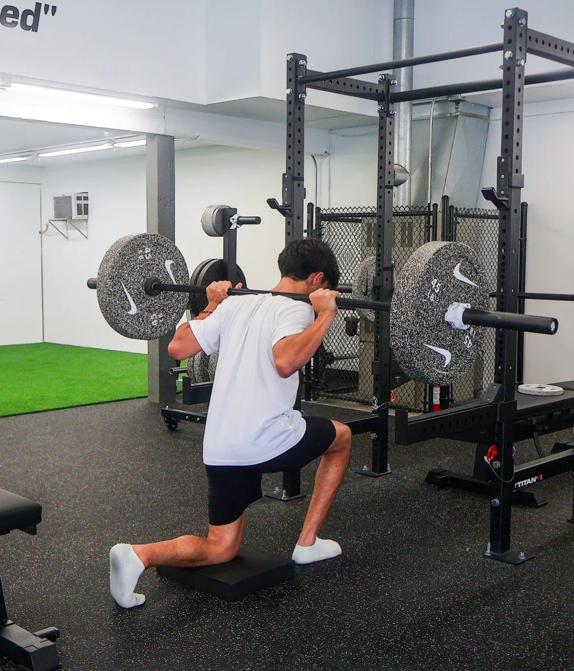 Athlete performing a barbell split squat at WSP