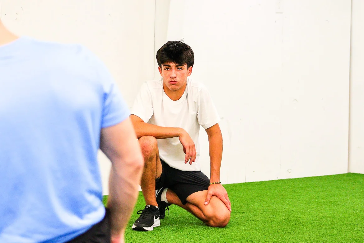 Coach working with an athlete on the WSP turf